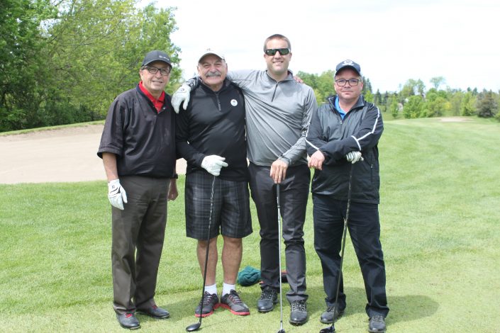 Four employees on the golf course at the Dufferin Concrete Golf Fundraiser Tournament